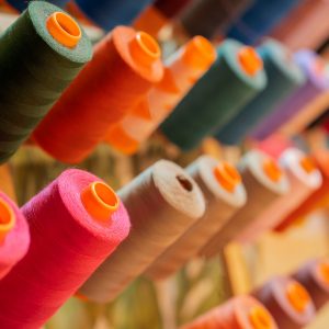 Close up view of a set of colorful sewing threads